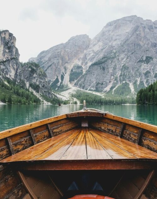 Small Boat in a lake surrounded by mountains