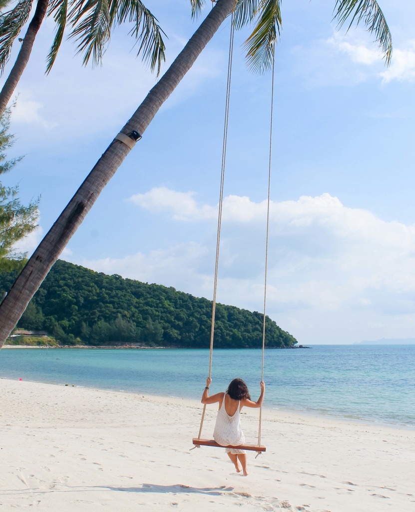 Woman on a beach swing