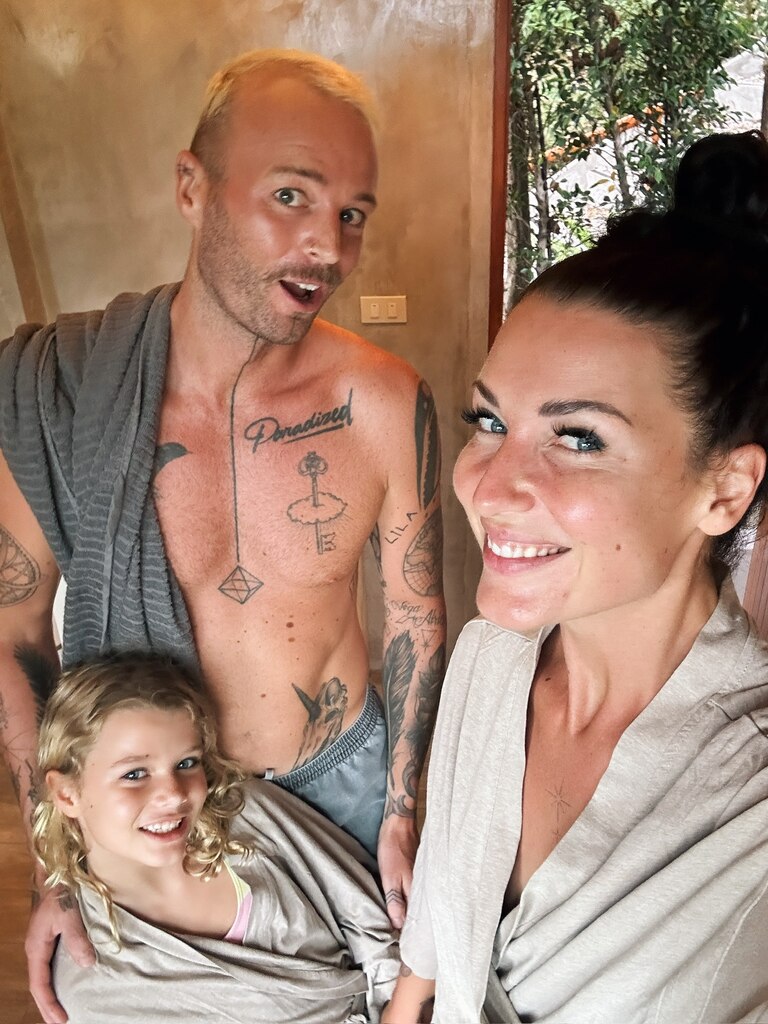 A family of three wearing bathrobes.