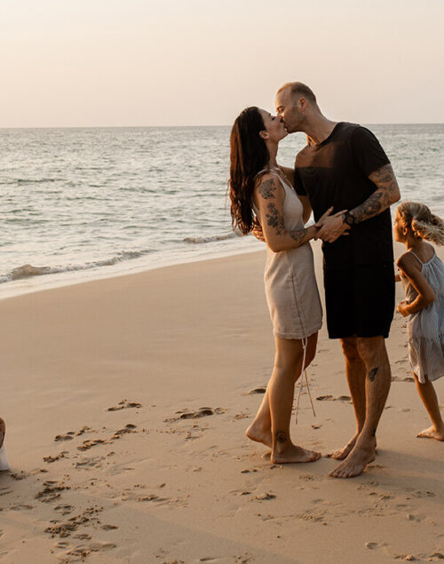 Family of four on a tropical beach.