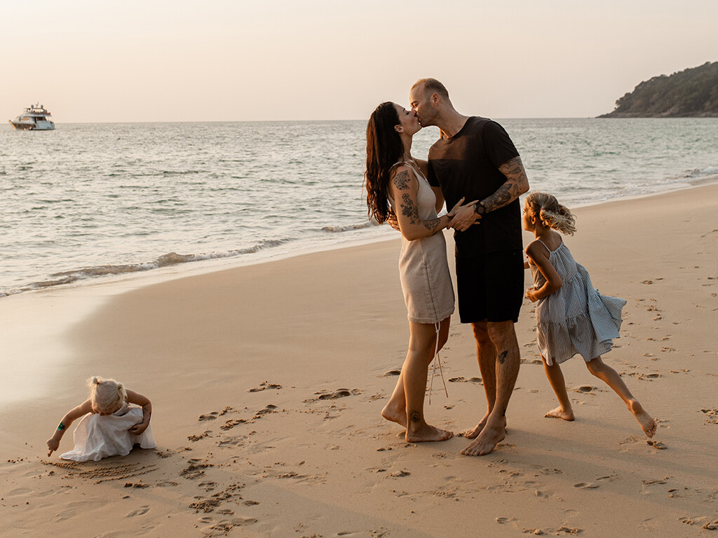 Family of four on a tropical beach.