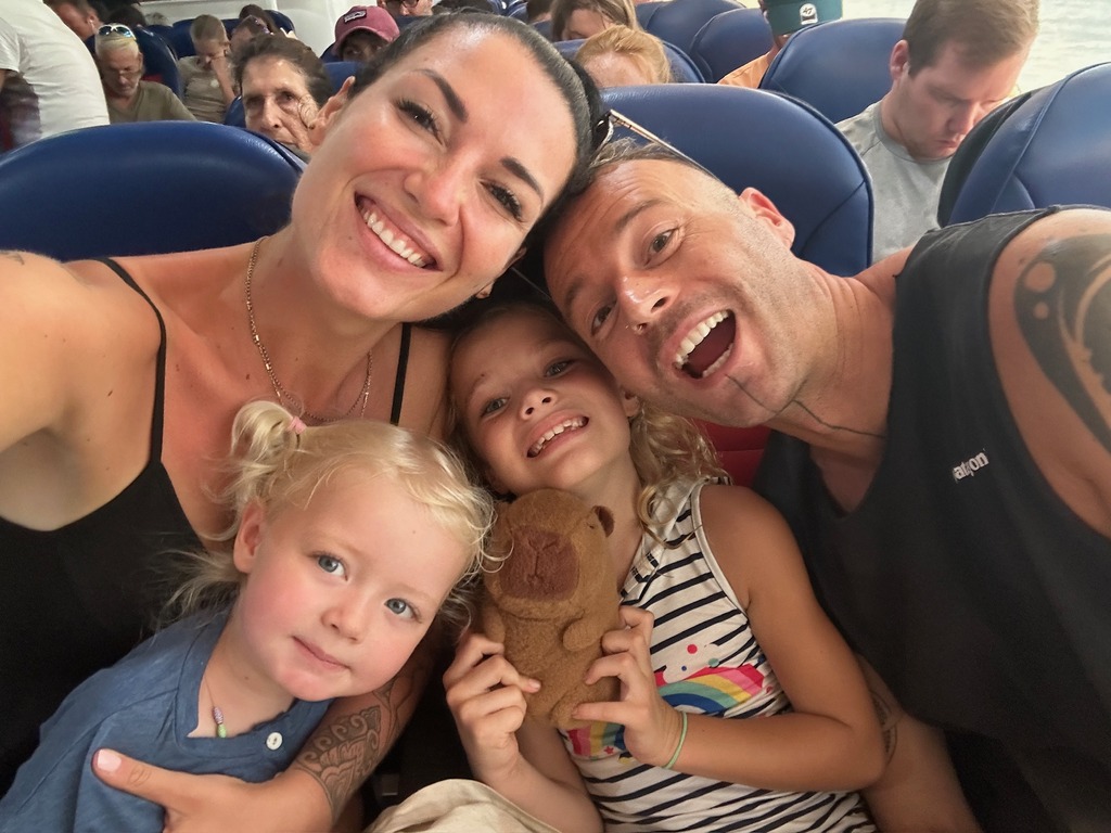 Family of four riding a ferry from Phuket to Koh Phangan