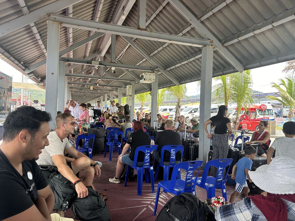 Seating area at pier with blue plastic chairs