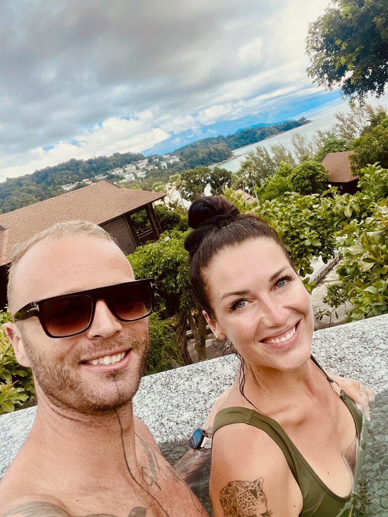 Couple taking a selfie in a pool.