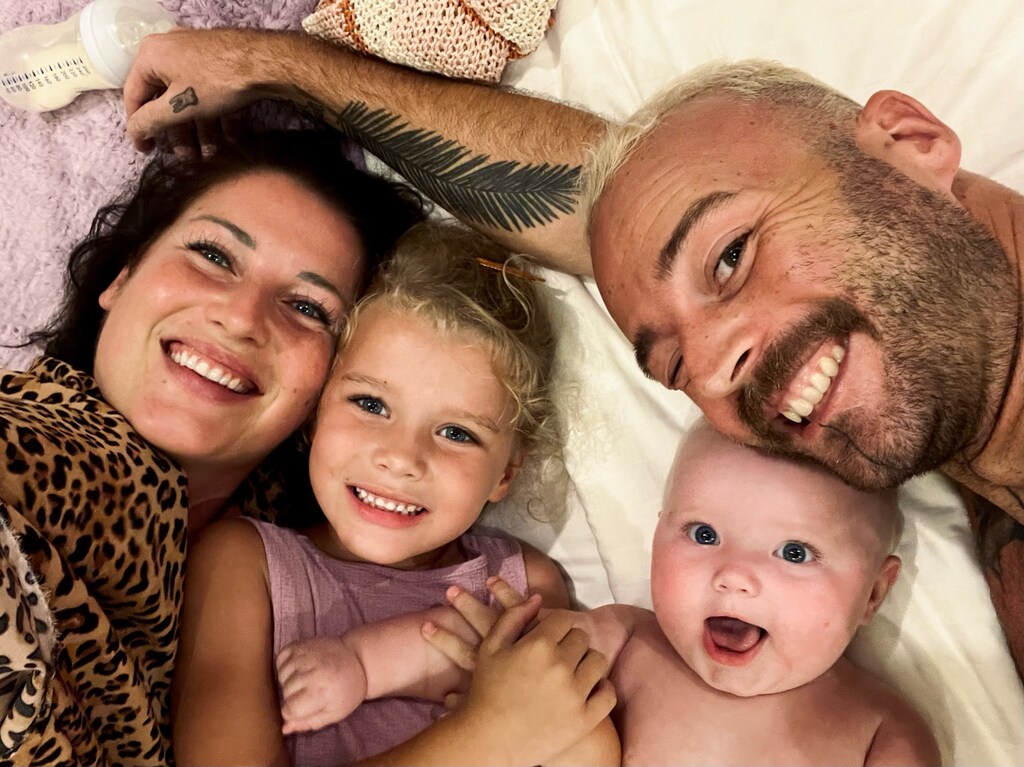 Family of four lying in a bed