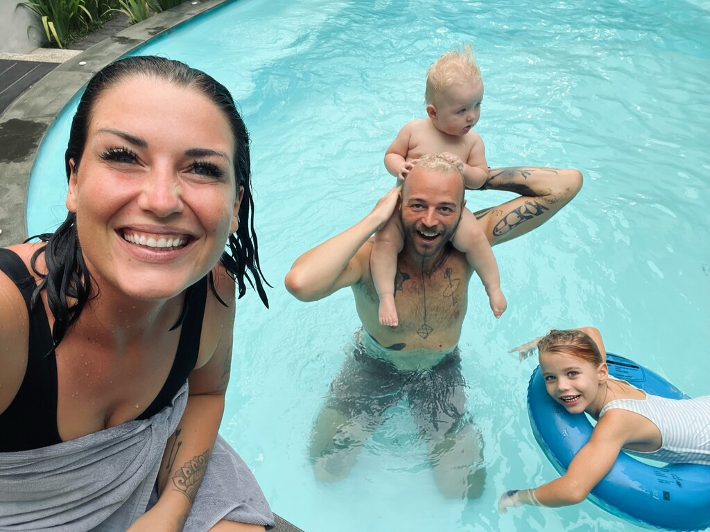 Thailand With a Baby: Safe, Easy & Fun in 2026 2 Family of four playing in a pool.