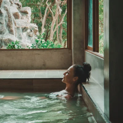 Woman sitting in Onsen Pool with closed eyes