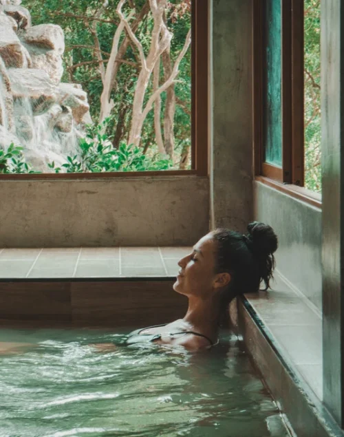 Woman sitting in Onsen Pool with closed eyes