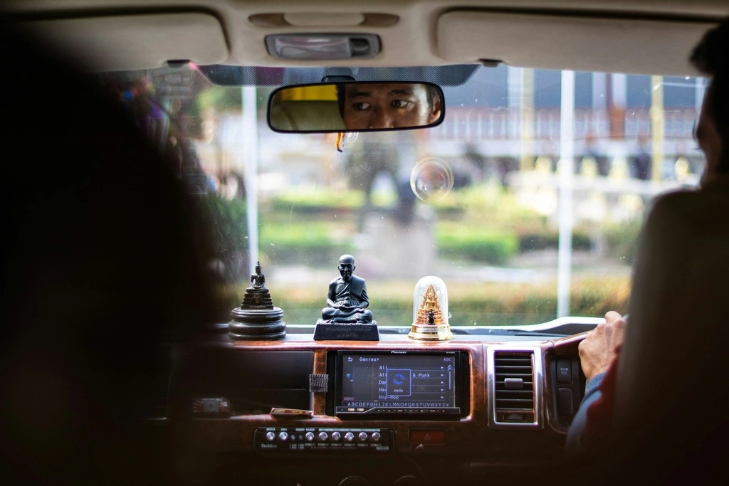 Taxi driver in Thailand sitting in his taxi.