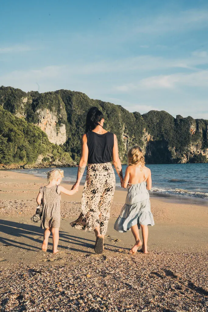 Mum and her two young daughters walking at a tropical beach. Krabi with Kids