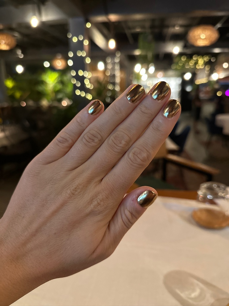 Hand with shiny gold nails