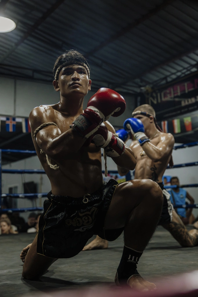 Two Muay Thai fighters performing the opening ceremony in the ring at a Muay Thai fight in Koh Phangan.