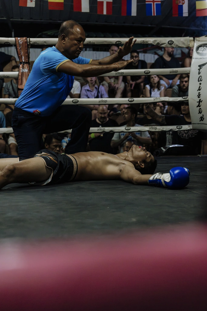 Referee signing a fight is over at a Muay Thai fight in Koh Phangan