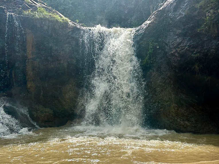 31 Best Things to Do in Koh Phangan: 2025 Guide 18 A waterfall cascading down rocks with brown-colored water.