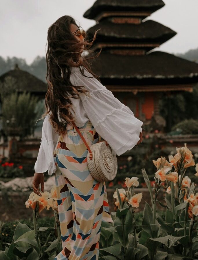 What to Wear in Thailand in 2026 – 20 Do's and Don'ts 31 Woman with white blouse and colorful wide pants.