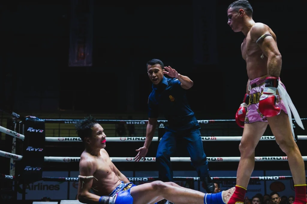 Two muay thai boxers fighting in the ring