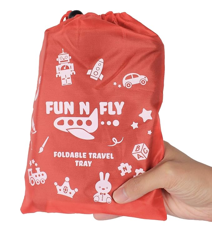 A hand holding a red bag.