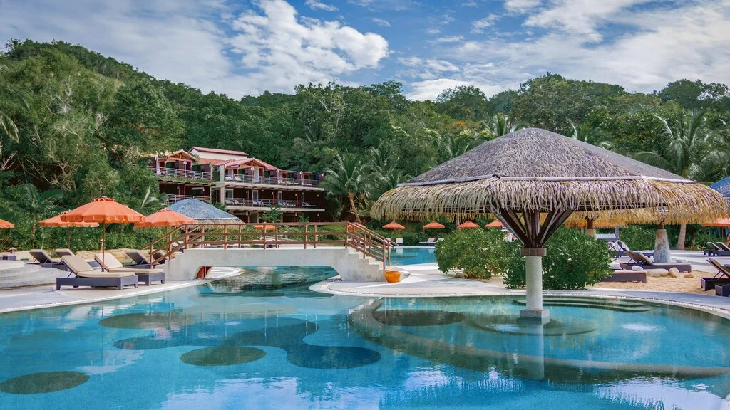 Big Hotel Pool with bamboo sun umbrellas