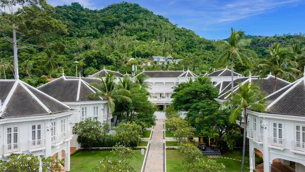 White colonial buildings in greenery