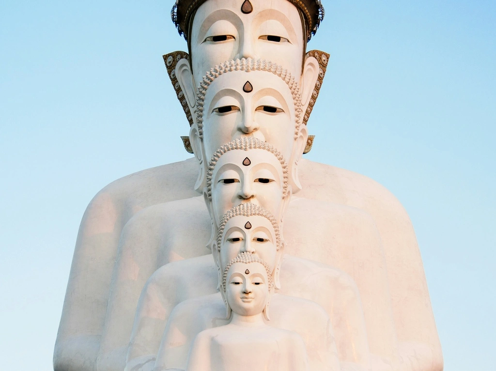 White Buddha statues lined up in front of each other, best time to visit southeast asia