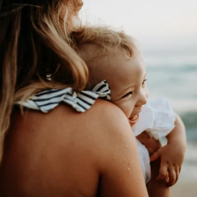 Mother with toddler on the beach