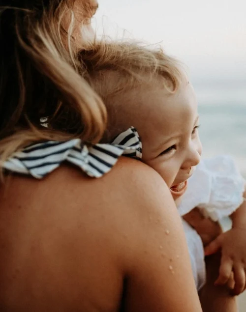 Mother with toddler on the beach