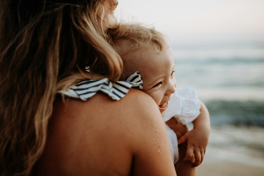 Mother with toddler on the beach