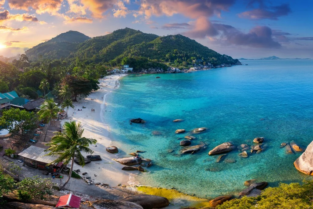 Aerial view of tropical beach with green hills in the background. Interesting facts about Thailand.