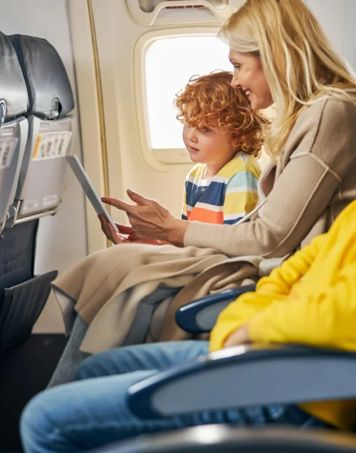 Mum with two young kids on a plane, How to Travel With a Toddler on a Plane