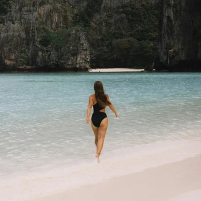 Woman walking on tropical beach, best time to travel to southeast asia