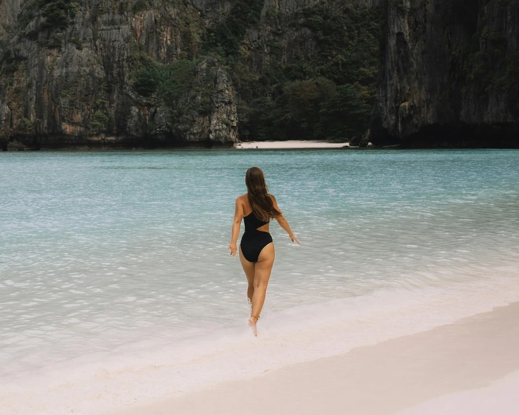 Woman walking on tropical beach, best time to travel to southeast asia