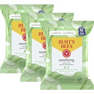 Three green packs of facial wipes.