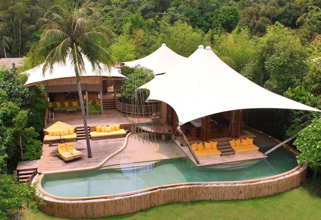 Luxury Hotel from above, private wooden villa with white sun sails