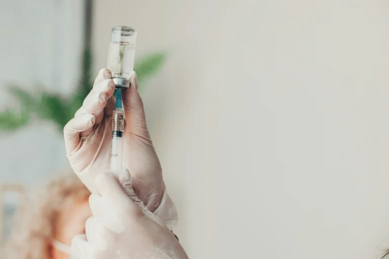 Hands holding a syringe, vaccines for Thailand travel