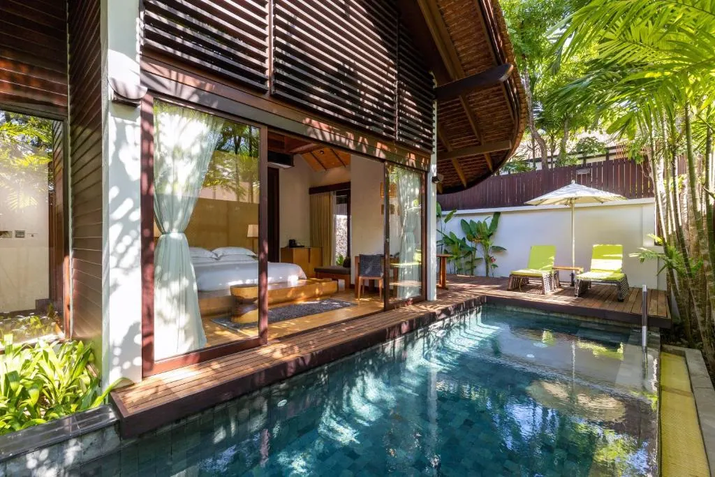 Wooden hotel room with private pool.