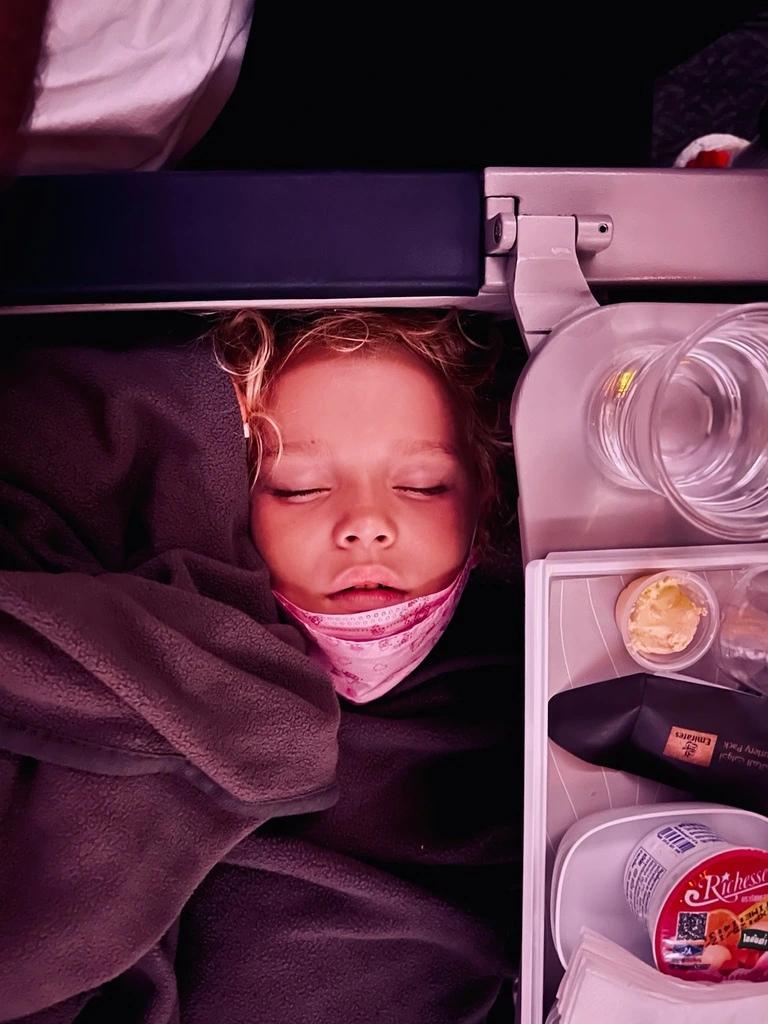 Young girl sleeping in a plane. Airplane Beds for Toddlers and Babies.