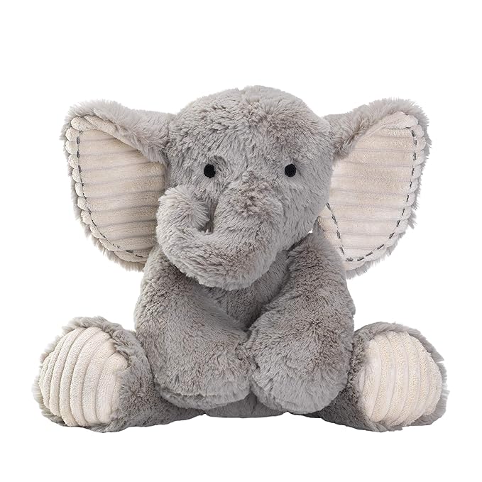 Stuffed toy, a grey elephant, sitting on white floor.