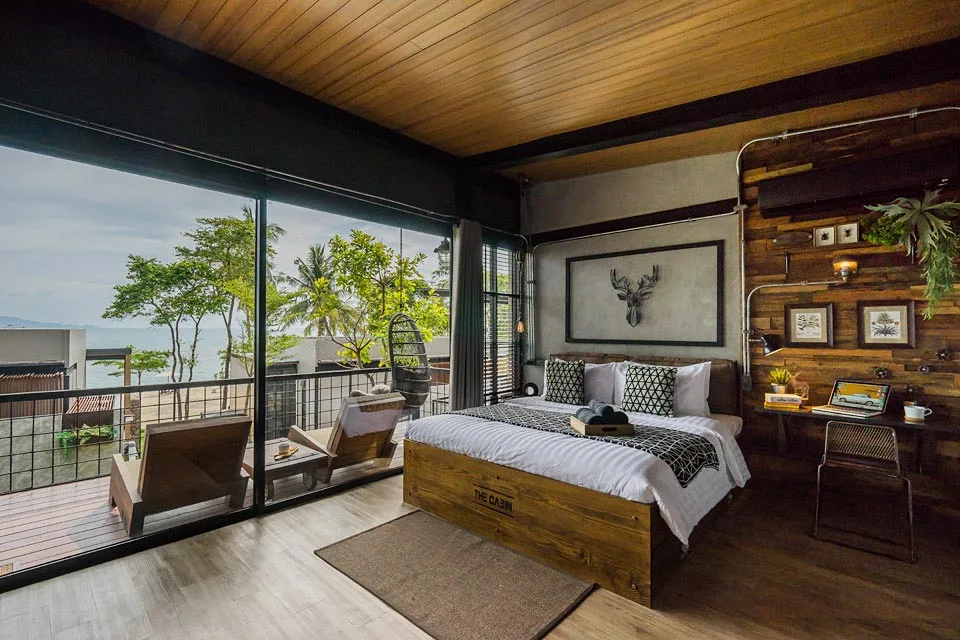 Cozy hotel room with wooden furniture and sea view.