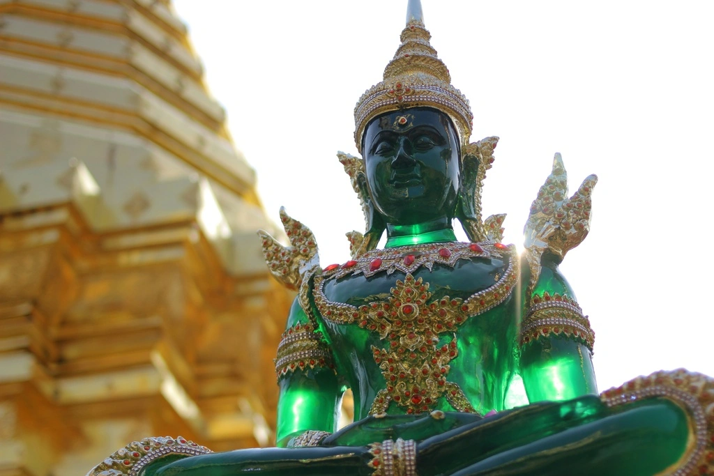 Black Buddha Statue in golden temple complex.