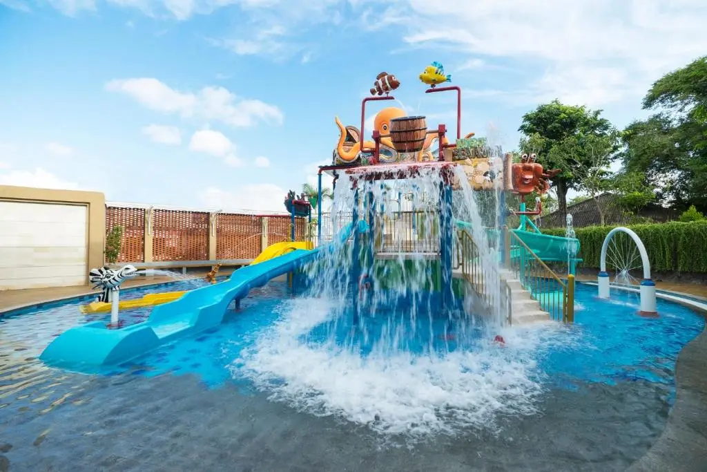 A water slide with a group of fish and a bucket on top.