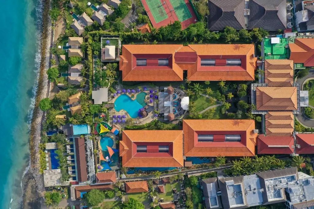 Aerial view of a resort with swimming pool and houses.