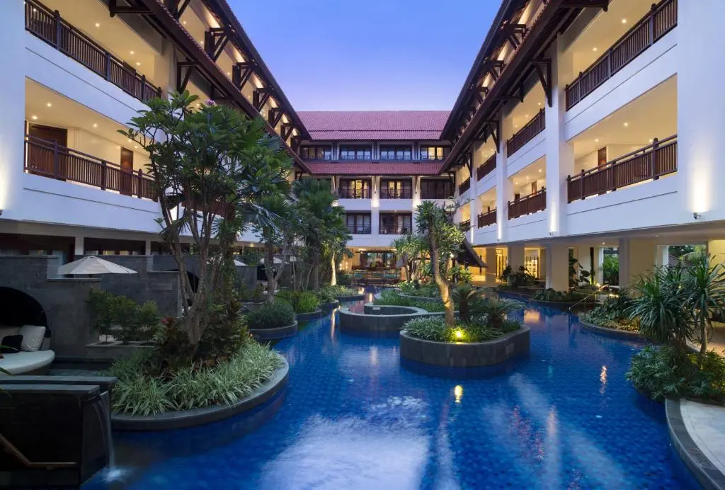 A pool surrounded by buildings left and right.