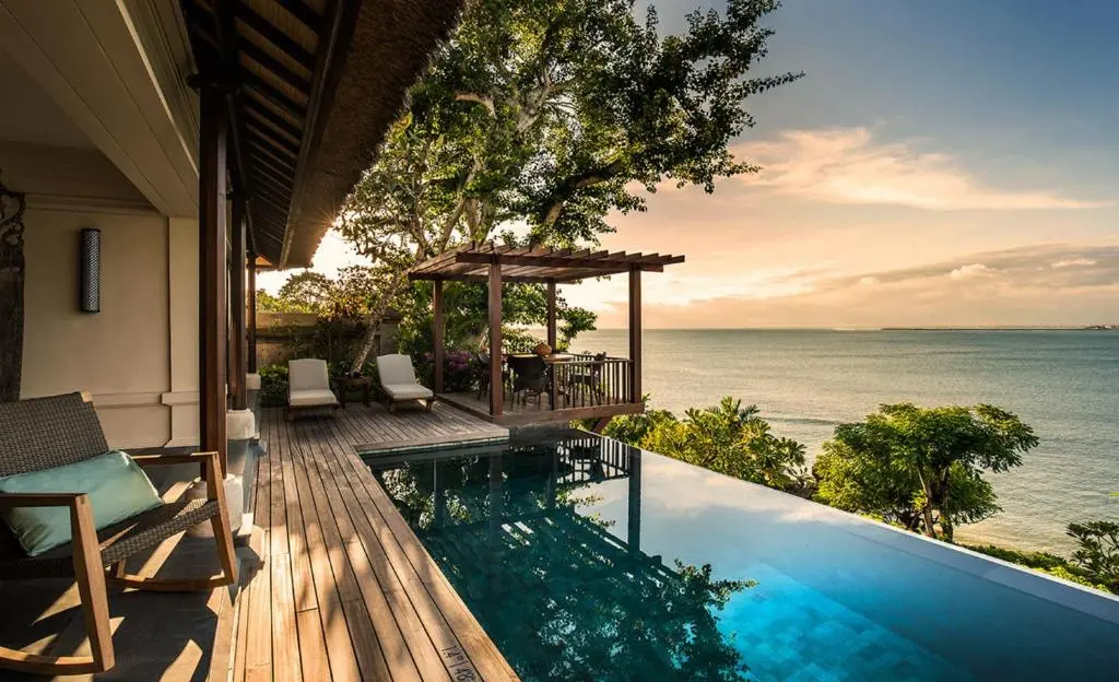 A swimming pool with a deck and ocean view.