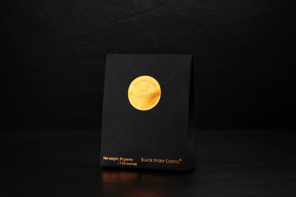 A black bag of coffee beans with a golden circle.