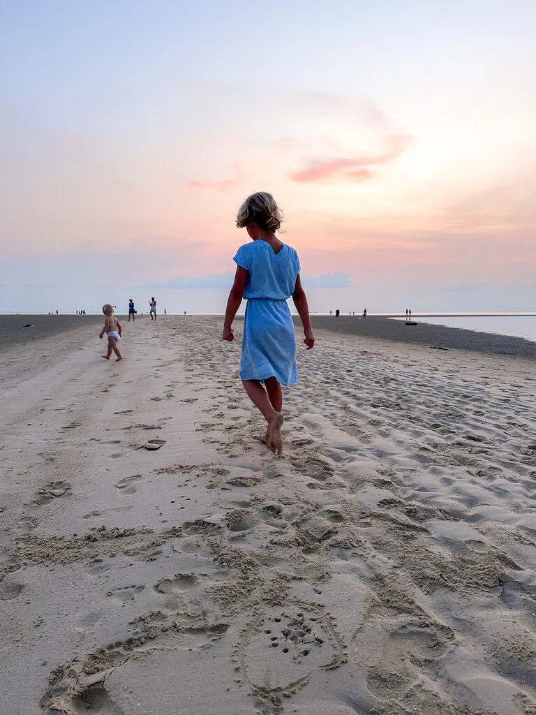 Guide to the Best Koh Phangan Beaches in 2025 10 A girl walking on a huge sandbank in front of a beach.