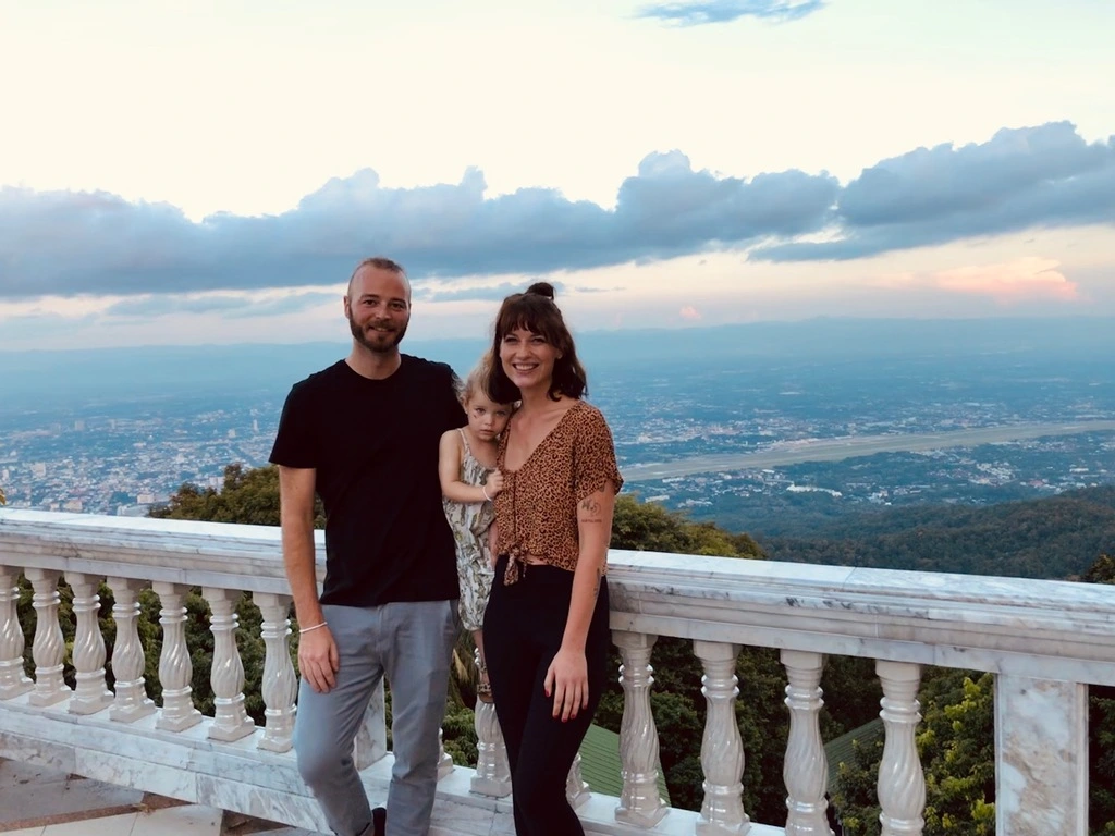 How Much is a Trip to Thailand? 2025 Breakdown 1 A family of three posing for a picture in front of a valley view in Thailand.
