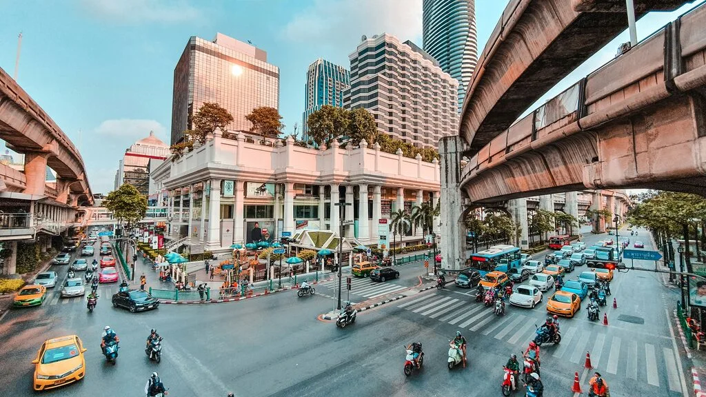 A city street with many cars and people.