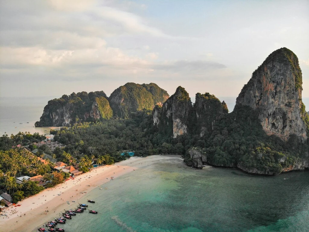 7-Day Thailand Family Trip: 2 Perfect Itinerary Ideas 10 A beach with boats and trees on the shore.