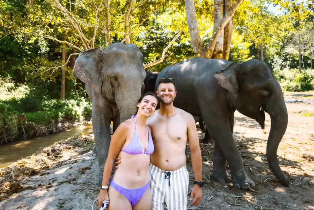 Ultimate 3-Day Chiang Mai Itinerary for First Timers 9 A man and woman standing in front of elephants.
