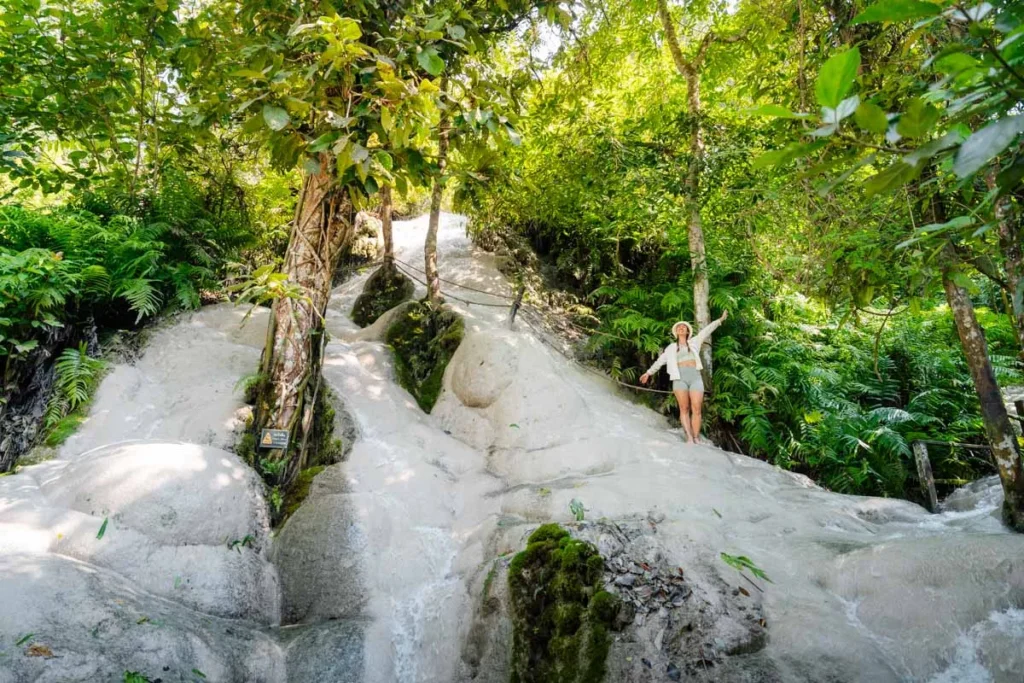 Ultimate 3-Day Chiang Mai Itinerary for First Timers 11 A woman standing on a rock with trees in the background.